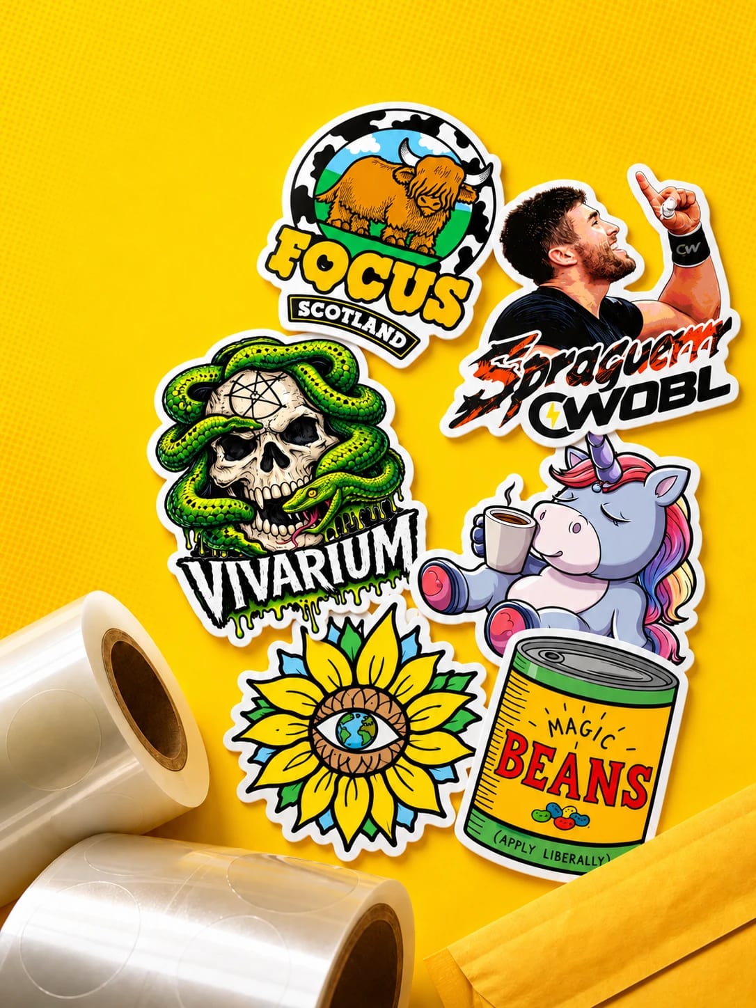 Colourful custom die-cut stickers next to rolls of sticker vinyl